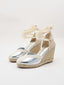 Silver wedge espadrilles with esparto sole and ribbons to tie at the ankle.