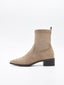 Women's ankle boot in taupe suede effect, mid-cut, with a fine toe and low black square heel.