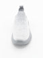 Zapatilla slip-on de punto knit en degradado gris con suela chunky ondulada gris y logo Nyrex en relieve.