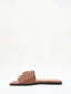 Flat brown sandals with gold buckle and square toe.