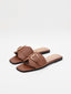 Flat brown sandals with gold buckle and square toe.